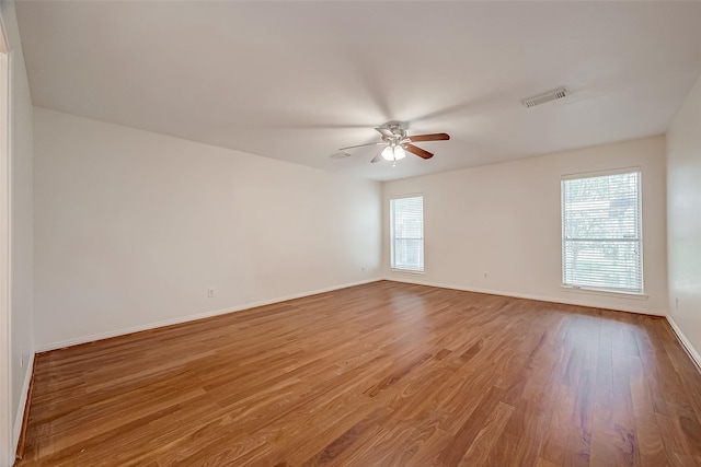 unfurnished room with hardwood / wood-style flooring and ceiling fan