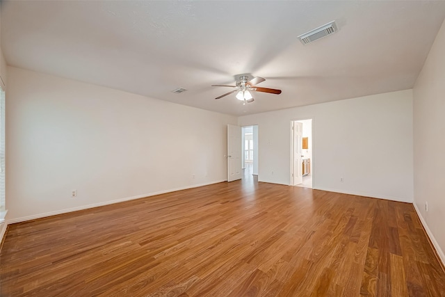 spare room with ceiling fan and light wood-type flooring