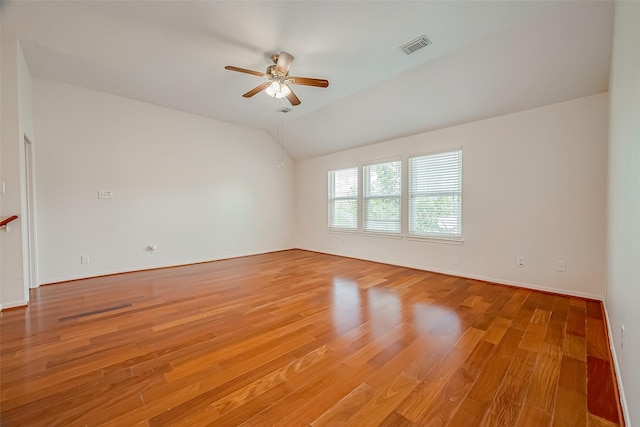 spare room featuring ceiling fan, wood-type flooring, and lofted ceiling