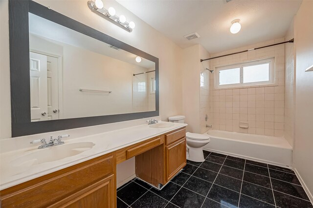 full bathroom with vanity, tiled shower / bath combo, and toilet