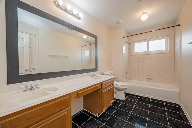 full bathroom with vanity, tiled shower / bath combo, and toilet