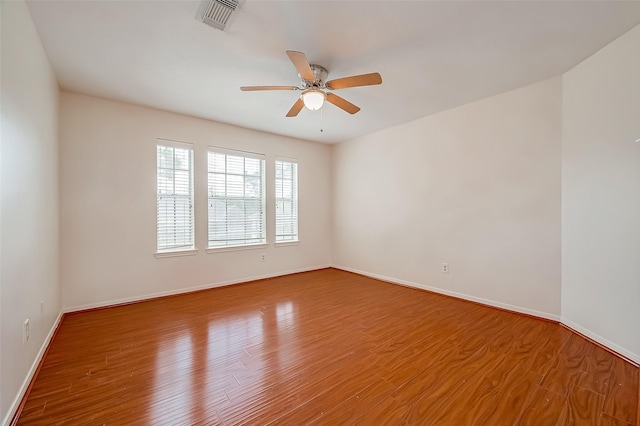 empty room featuring ceiling fan and hardwood / wood-style floors