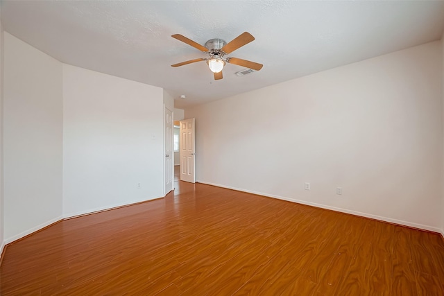 unfurnished room with ceiling fan and hardwood / wood-style flooring