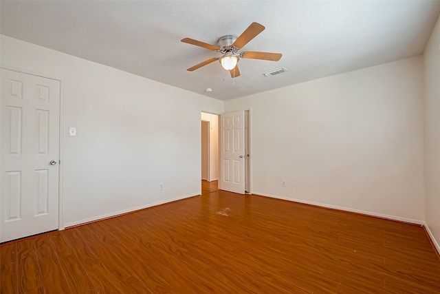 empty room with ceiling fan and wood-type flooring