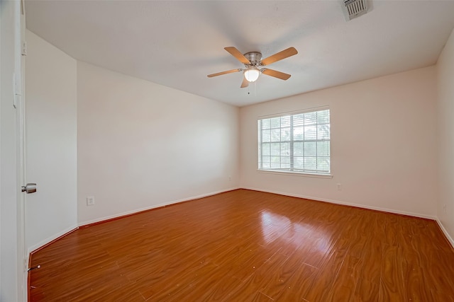 spare room featuring hardwood / wood-style floors and ceiling fan