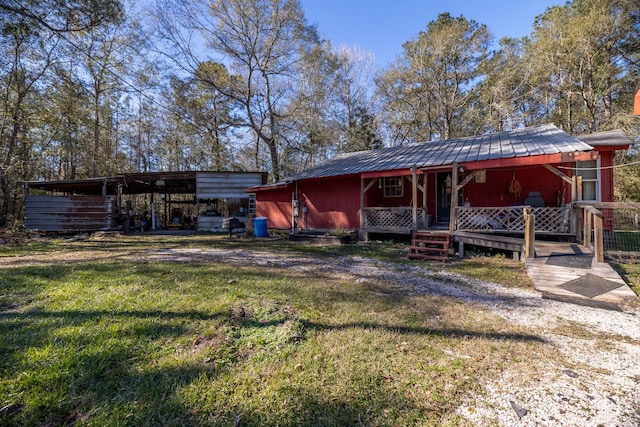 back of property featuring a lawn and a porch