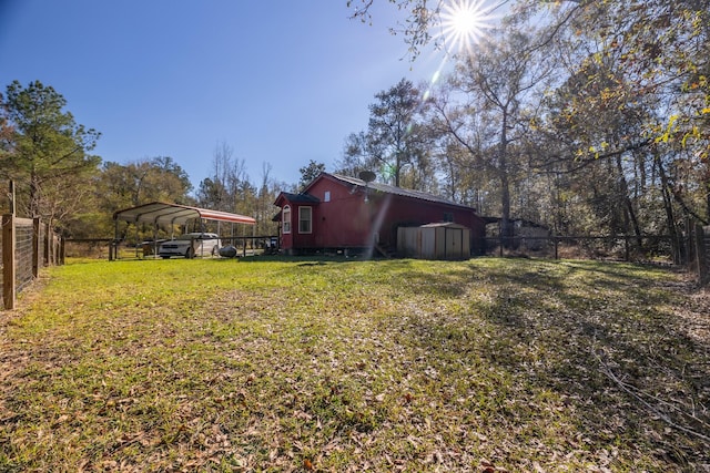 view of yard featuring a carport and a storage shed