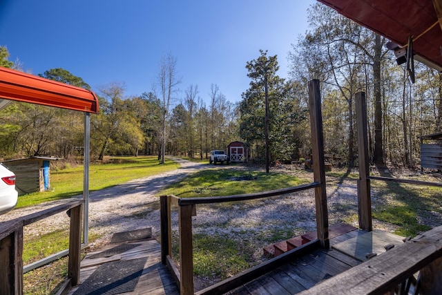 exterior space featuring a deck and a storage shed