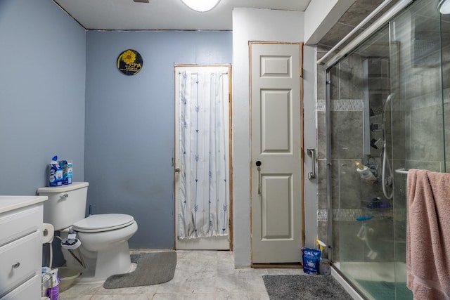 bathroom featuring tile patterned floors, toilet, vanity, and walk in shower