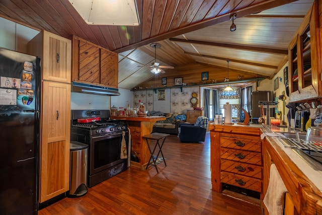 kitchen featuring tile countertops, black refrigerator, ceiling fan, decorative light fixtures, and stainless steel range with gas stovetop