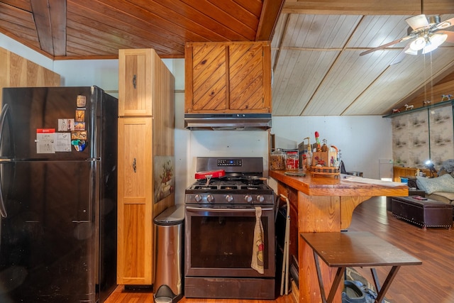 kitchen with black fridge, stainless steel range with gas cooktop, ceiling fan, wood-type flooring, and wood ceiling