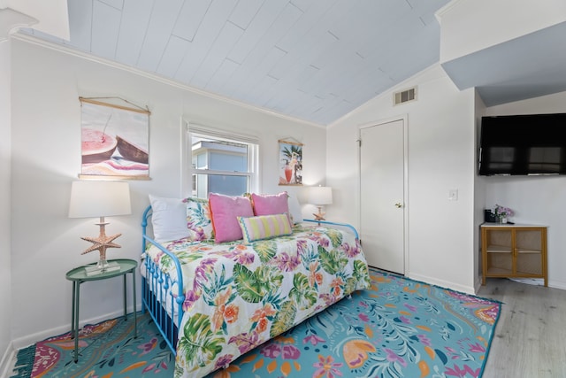 bedroom featuring hardwood / wood-style flooring, wooden ceiling, ornamental molding, and vaulted ceiling