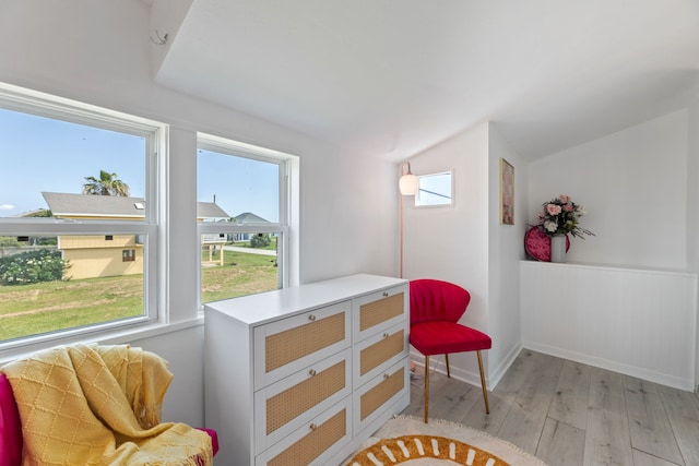 sitting room with light hardwood / wood-style flooring and lofted ceiling