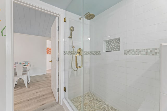 bathroom featuring wood-type flooring and walk in shower