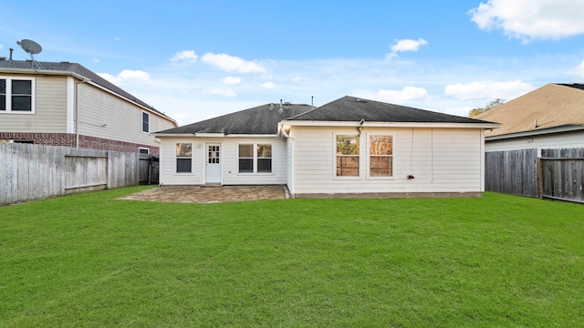 rear view of property featuring a yard