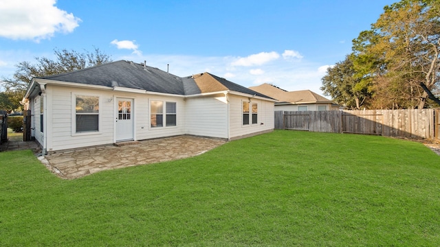 rear view of house featuring a yard