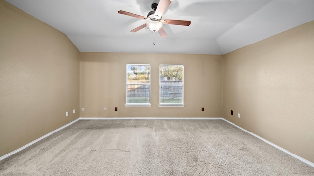 unfurnished room featuring lofted ceiling, ceiling fan, and carpet