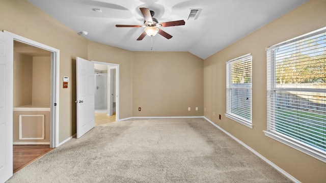 carpeted spare room with lofted ceiling and ceiling fan