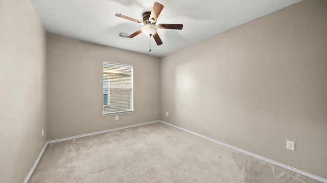 empty room featuring light carpet and ceiling fan