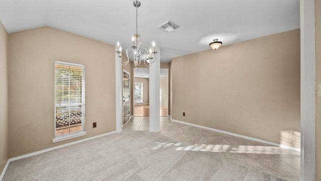 carpeted spare room featuring an inviting chandelier and vaulted ceiling