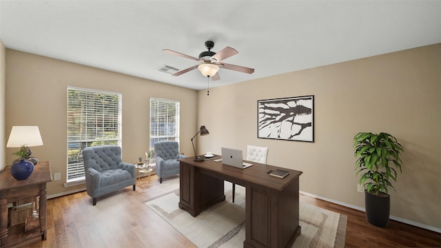 office with ceiling fan and light wood-type flooring