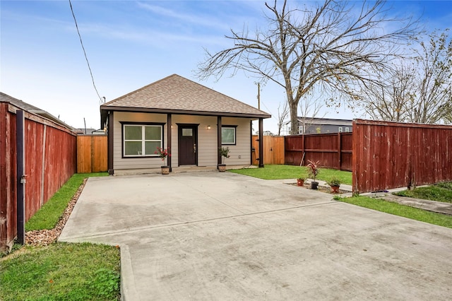 rear view of property featuring a yard