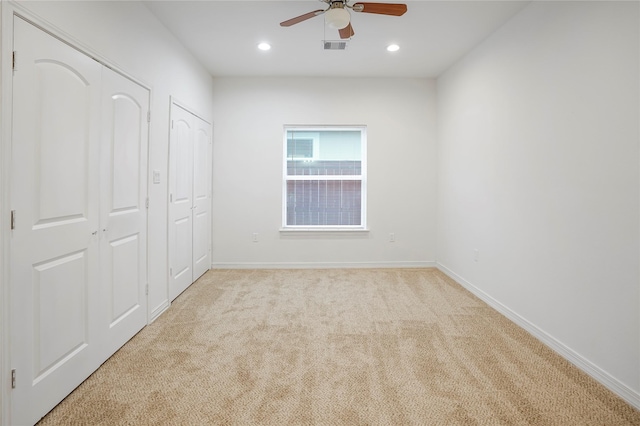 unfurnished bedroom featuring ceiling fan and light colored carpet