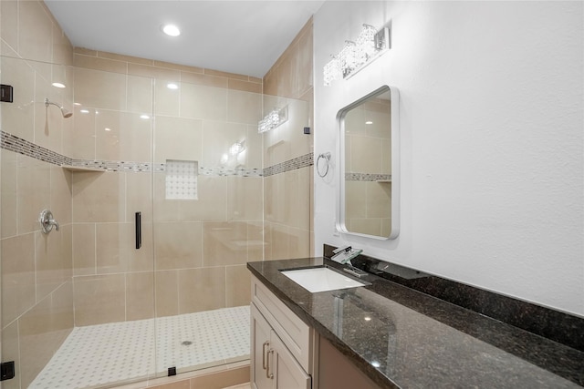 bathroom with vanity and a shower with shower door