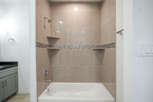 bathroom featuring vanity and tiled shower / bath