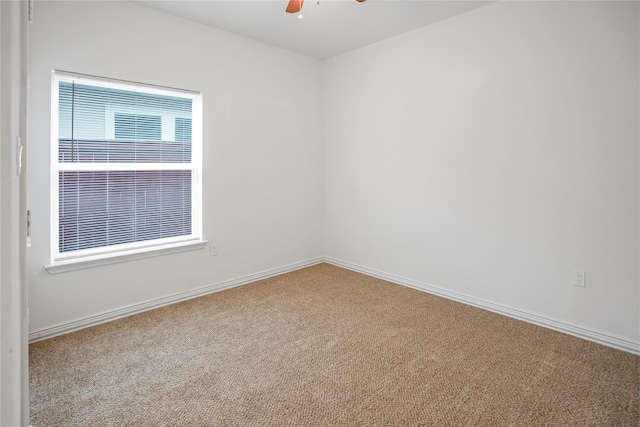 spare room with carpet flooring, ceiling fan, and a healthy amount of sunlight