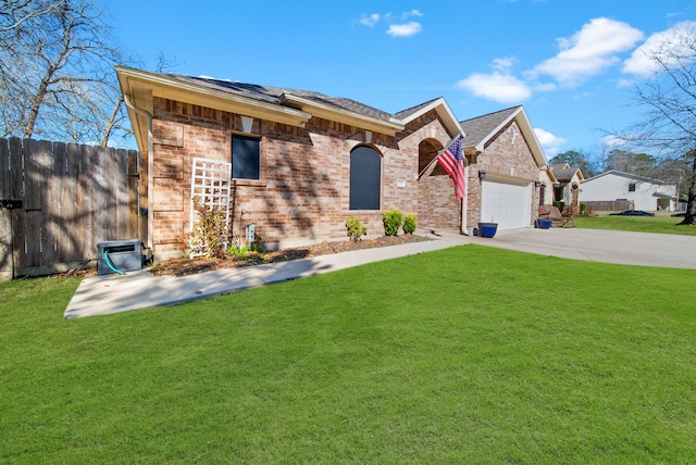 ranch-style home with a garage and a front yard