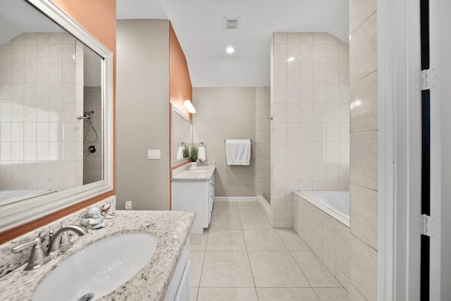 bathroom featuring tile patterned flooring, shower with separate bathtub, and vanity