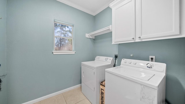 laundry area featuring cabinets, independent washer and dryer, ornamental molding, and light tile patterned floors