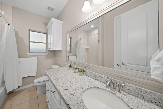 bathroom with tile patterned flooring, vanity, and toilet