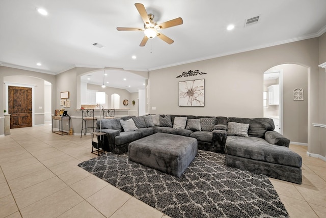 tiled living room featuring ceiling fan and ornamental molding