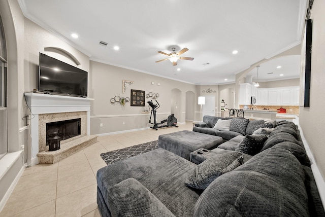 tiled living room featuring crown molding and ceiling fan