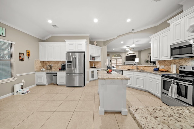 kitchen featuring lofted ceiling, white cabinets, sink, ceiling fan, and appliances with stainless steel finishes