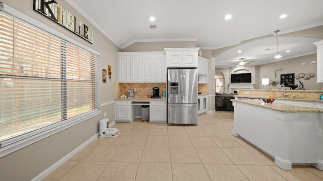 kitchen with decorative backsplash, stainless steel appliances, vaulted ceiling, and white cabinets