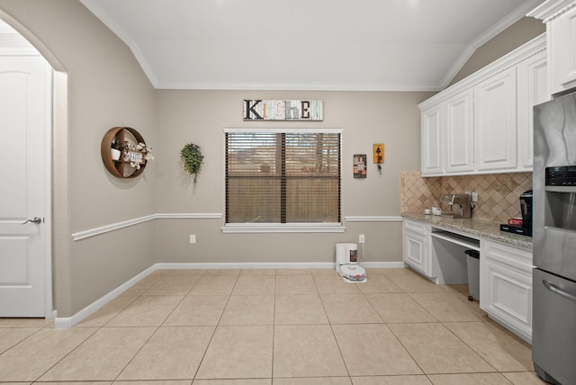 kitchen with lofted ceiling, white cabinetry, light stone counters, and stainless steel refrigerator with ice dispenser