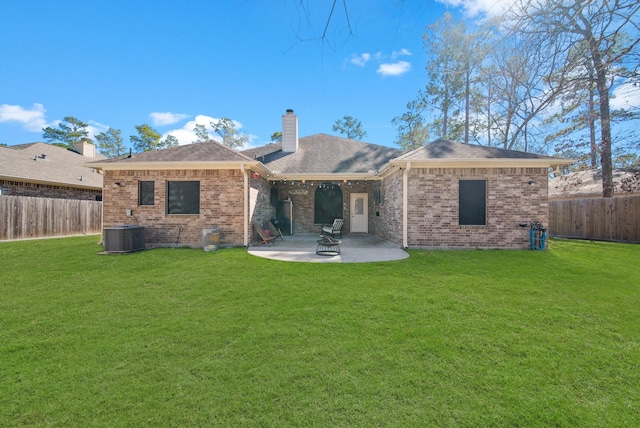 rear view of property featuring central AC unit, a patio area, and a lawn