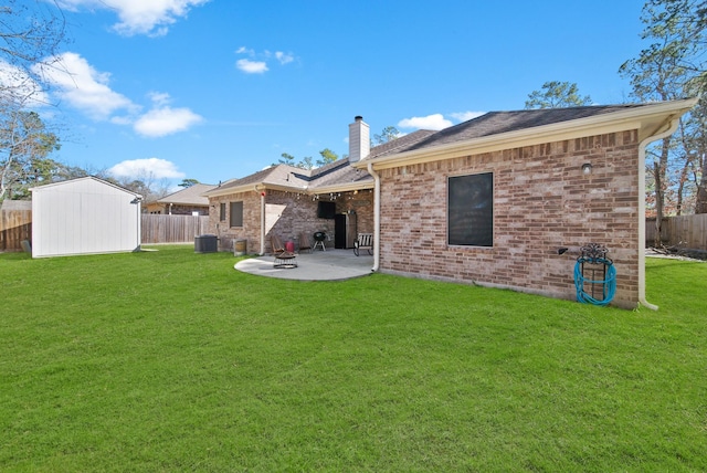 back of property featuring central AC unit, a storage unit, a patio area, and a yard