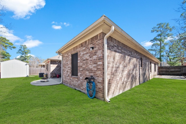 view of home's exterior featuring a yard, a patio, and a storage shed