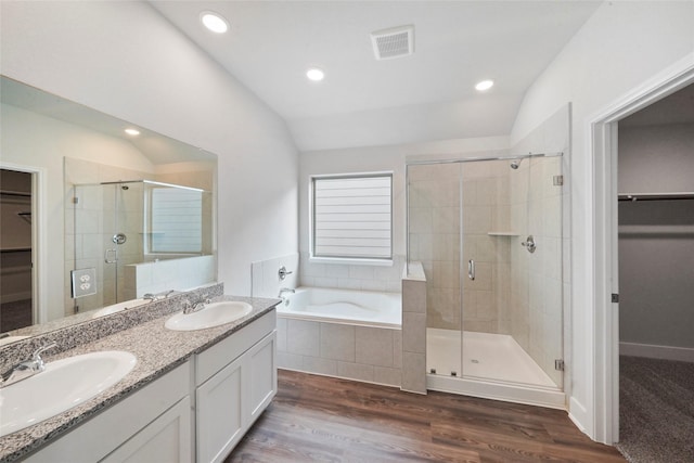 bathroom featuring separate shower and tub, vanity, vaulted ceiling, and hardwood / wood-style flooring