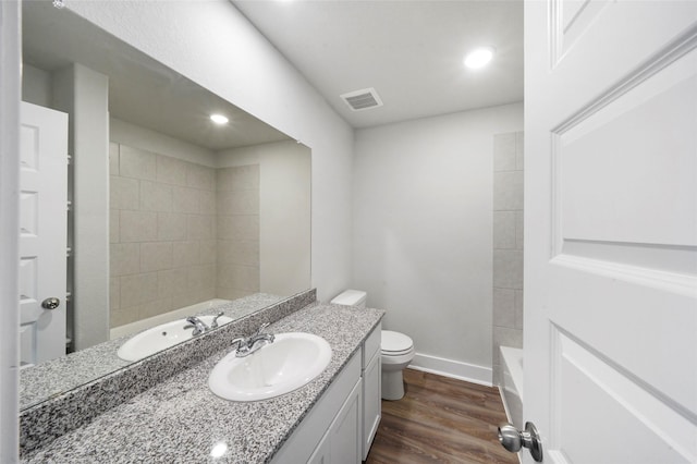 bathroom featuring hardwood / wood-style flooring, vanity, and toilet