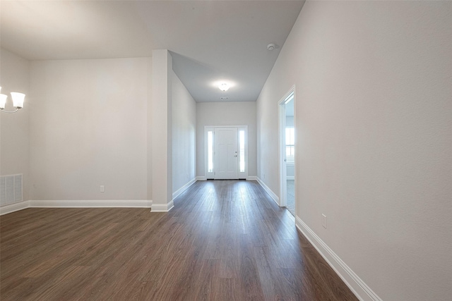 interior space with dark hardwood / wood-style floors and a notable chandelier