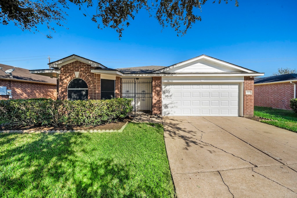 ranch-style house with a front yard and a garage