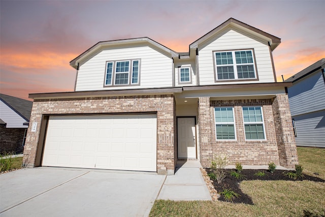 view of front of house featuring a garage and a yard