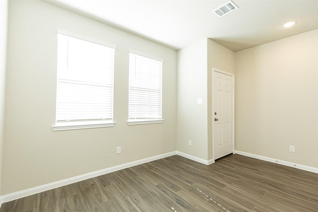 spare room with dark wood-type flooring