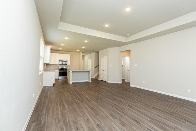 unfurnished living room featuring dark hardwood / wood-style flooring