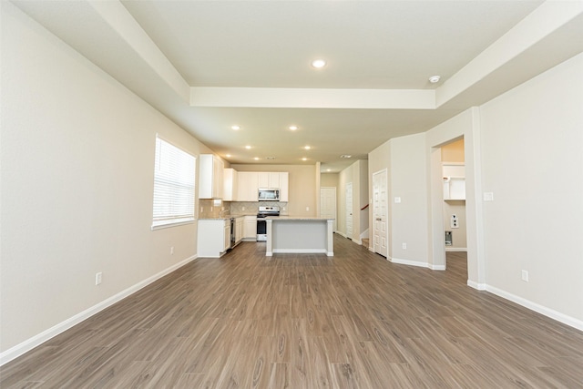 unfurnished living room featuring hardwood / wood-style flooring